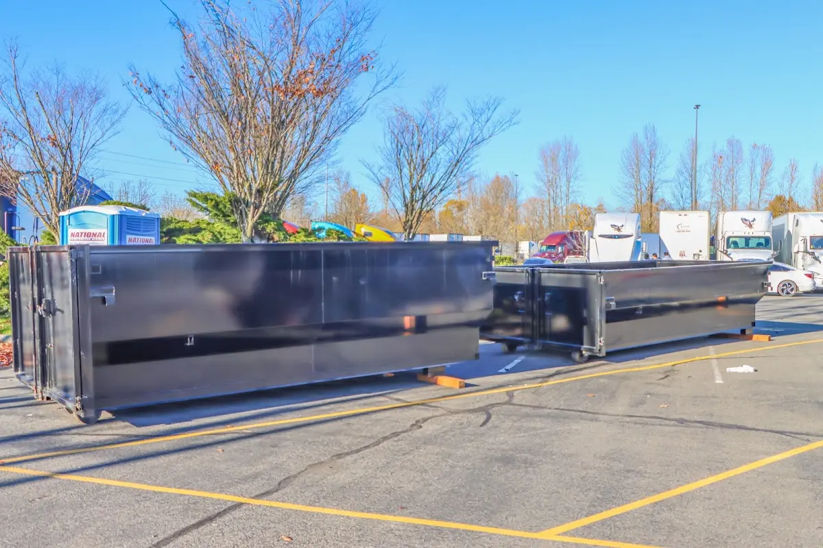 Professional dumpster rental service with roll-off container on residential driveway in South Kensington